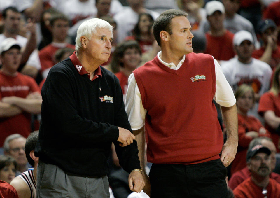 FILE -Texas Tech head basketball coach Bob Knight, left, stands by his son and head coach designate, Pat Knight, right, during a NCAA basketball game against Texas A&M in Lubbock, Texas, Wednesday, Jan. 16, 2008. Coach Bob Knight earned his 900th career win with the 68-53 victory. Bob Knight, the brilliant and combustible coach who won three NCAA titles at Indiana and for years was the scowling face of college basketball has died. He was 83. Knight's family made the announcement on social media Wednesday evening, Nov. 1, 2023. (AP Photo/Tony Gutierrez, File)