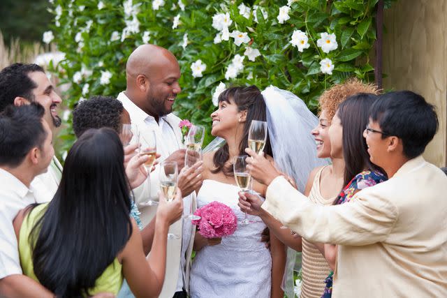 <p>Getty</p> Stock photo of wedding guests