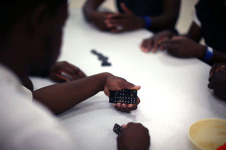 Men play dominoes at the Adelanto immigration detention center, which is run by the Geo Group Inc (GEO.N), in Adelanto, California, U.S., April 13, 2017. REUTERS/Lucy Nicholson