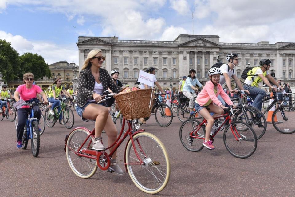 Members of the public ride by Buckingham Palace during the Prudential RideLondon FreeCycle (Rex Features)