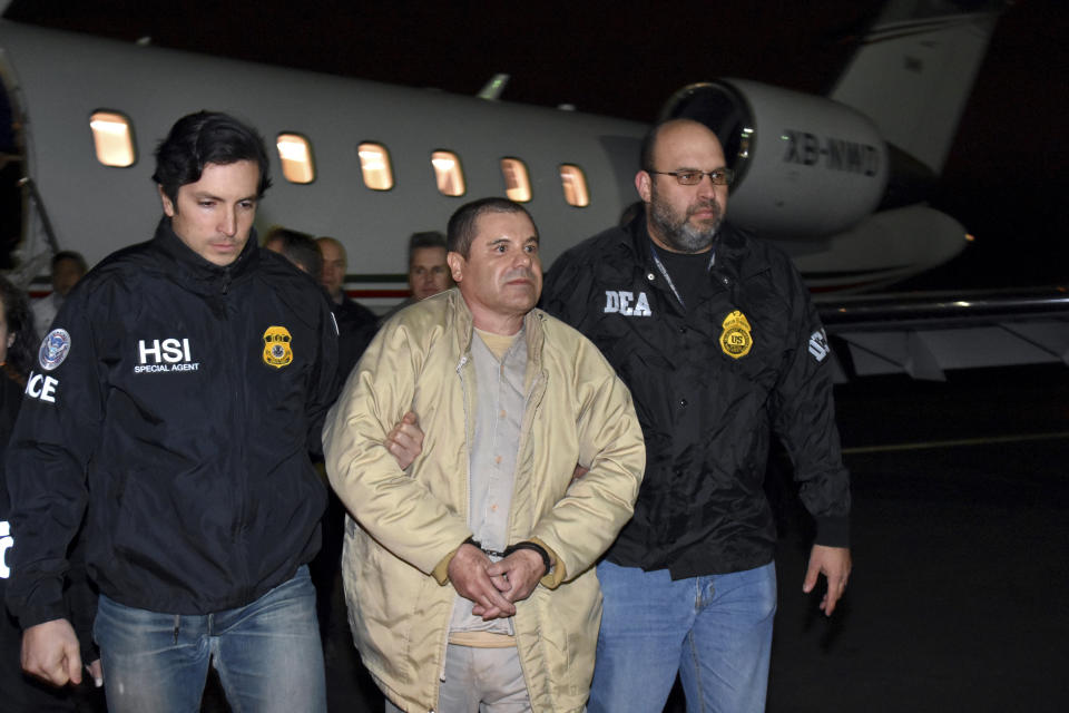 Joaquin "El Chapo" Guzman is escorted from a plane to a waiting caravan of SUVs in New York's Long Island on Jan. 19, 2017. (Photo: Associated Press)