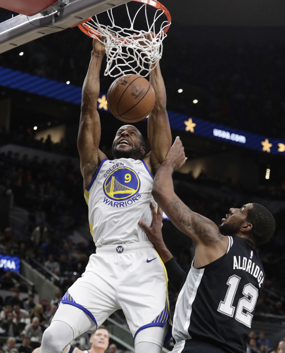 Golden State Warriors guard Andre Iguodala (9) scores over San Antonio Spurs forward LaMarcus Aldridge (12) during the first half of an NBA basketball game Sunday, Nov. 18, 2018, in San Antonio. (AP Photo/Eric Gay)