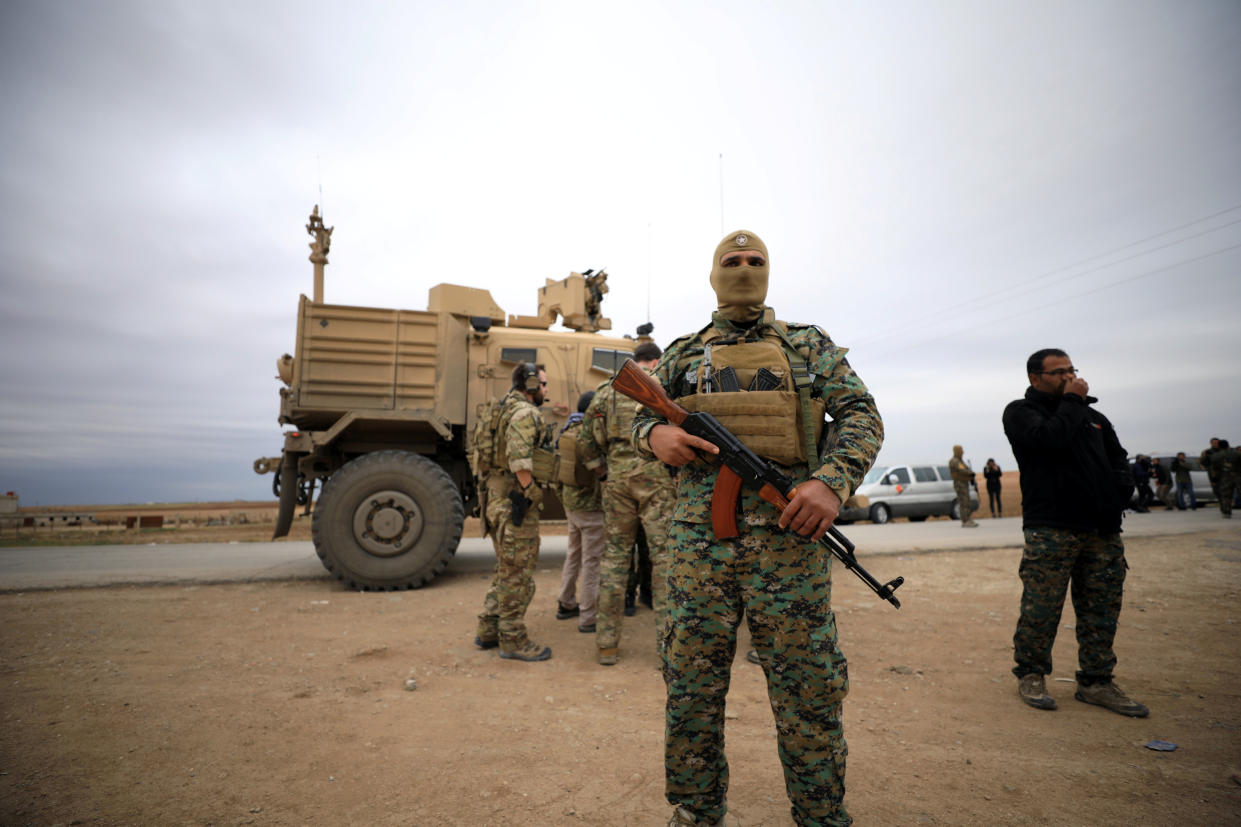 Syrian Democratic Forces and U.S. troops are seen during a patrol near the Turkish border in Hasakah, Syria, last November. (Photo: Rodi Said/Reuters)