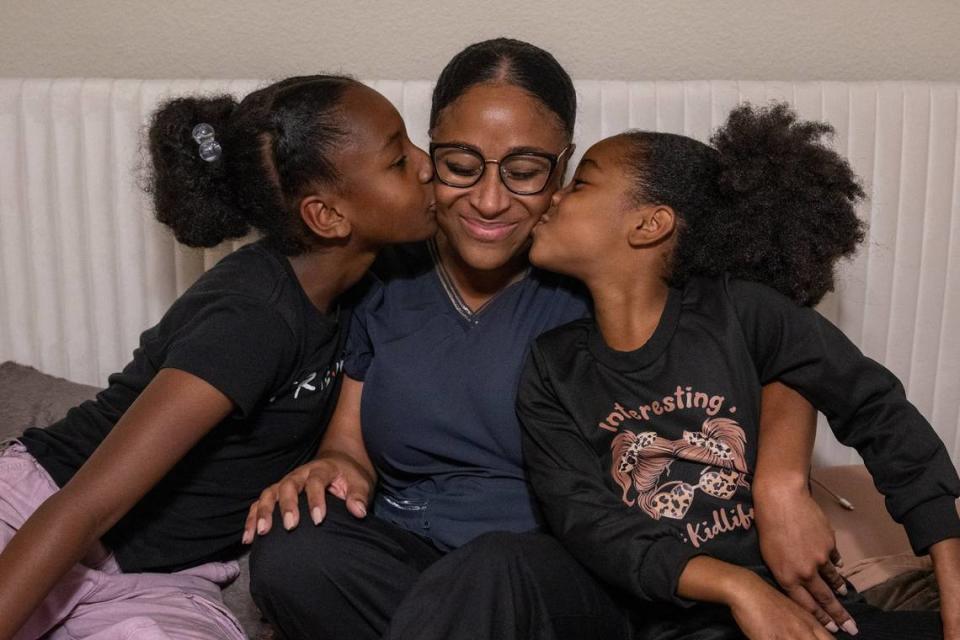 Nia Love said the love from her daughters Lyric, 11, left, and Adaya, 9, right, kissing their mother in October, helped her recover after she was blinded in her left eye by a rubber bullet in 2020 while participating in a George Floyd protest in Sacramento. “I feel like the cause we were protesting resulted in more violence then needed,” she said. “There needs to be more accountability when it comes to issues like this.”