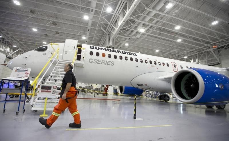 A Bombardier worker walks past the CS300 Aircraft in the hangar prior to its' test flight in Mirabel February 27, 2015. REUTERS/Christinne Muschi
