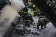 <p>Nepalese rescuers work amid the debris after a passenger plane from Bangladesh crashed at the airport in Kathmandu, Nepal, March 12, 2018. (Photo: Niranjan Shreshta/AP) </p>