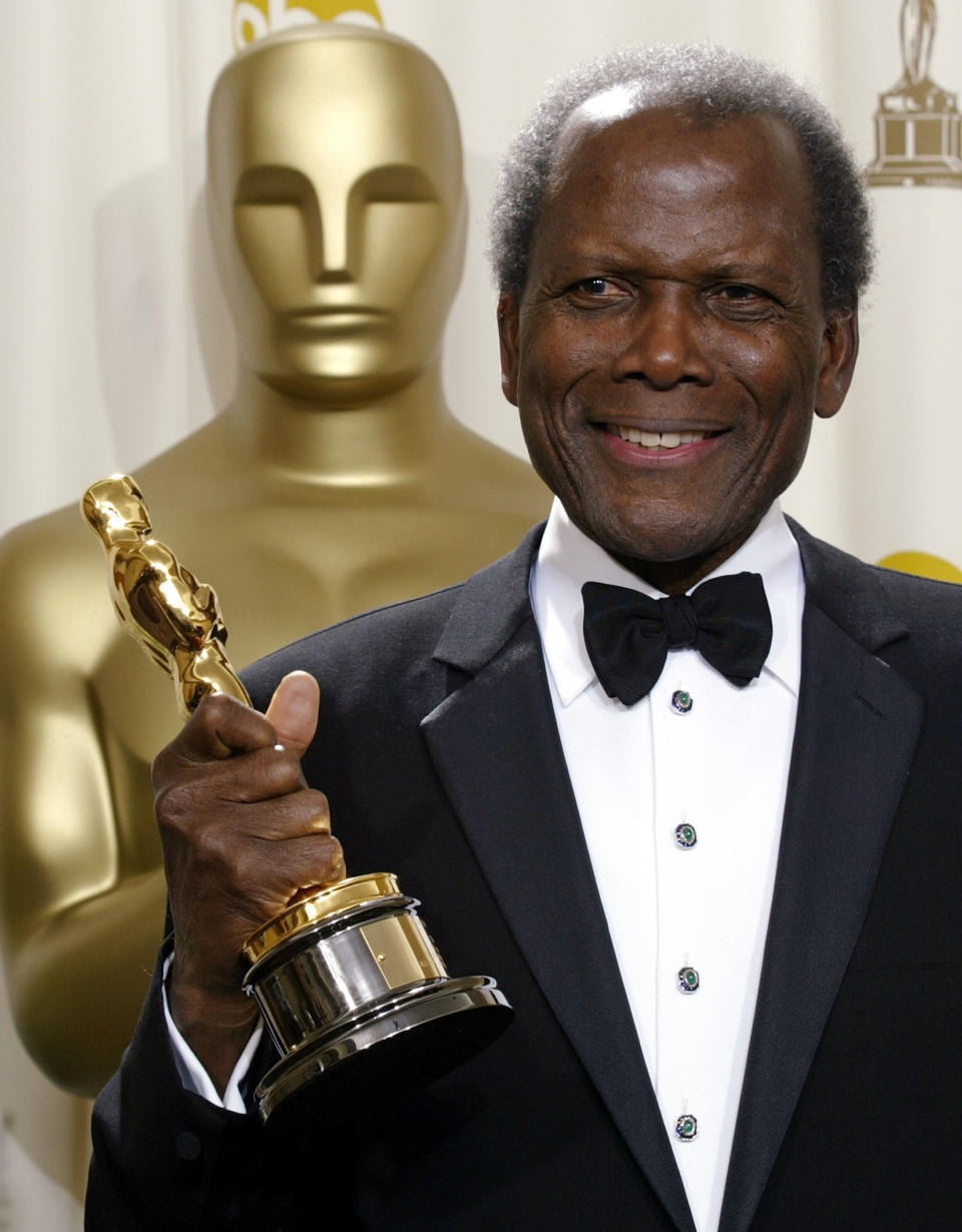 FILE - Sidney Poitier poses with his honorary Oscar during the 74th annual Academy Awards on March 24, 2002, in Los Angeles. Among the entertainers who died in 2022 was groundbreaking actor Poitier, who played roles with such dignity that it helped change the way Black people were portrayed on screen. Poitier, who died in January, became the first Black actor to win the Academy Award for Best Actor for his role in the 1963 film “Lilies of the Field." (AP Photo/Doug Mills, File)