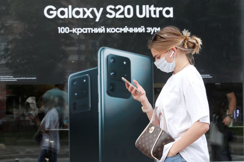 FILE PHOTO: A woman walks past a Samsung brand store in central Kyiv