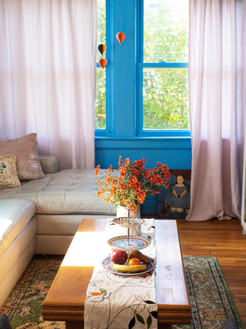 A leather couch behind a coffee table with decorative items a top.