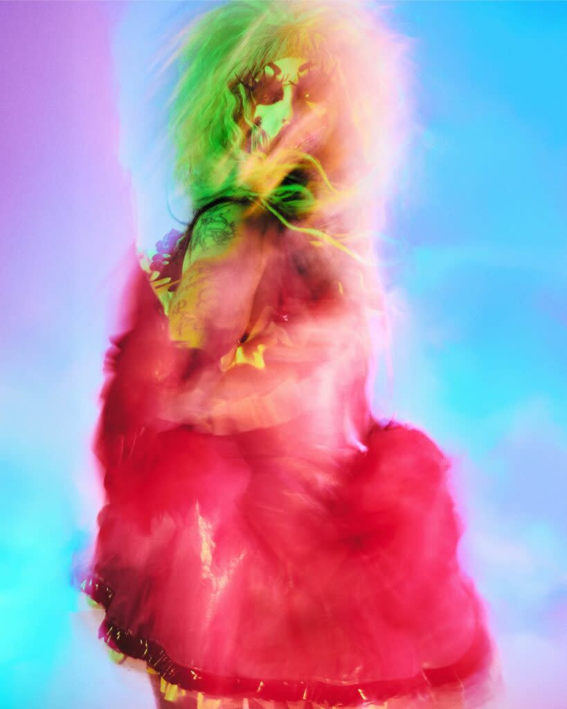 Stylised image of a drag artist against a gradient backdrop