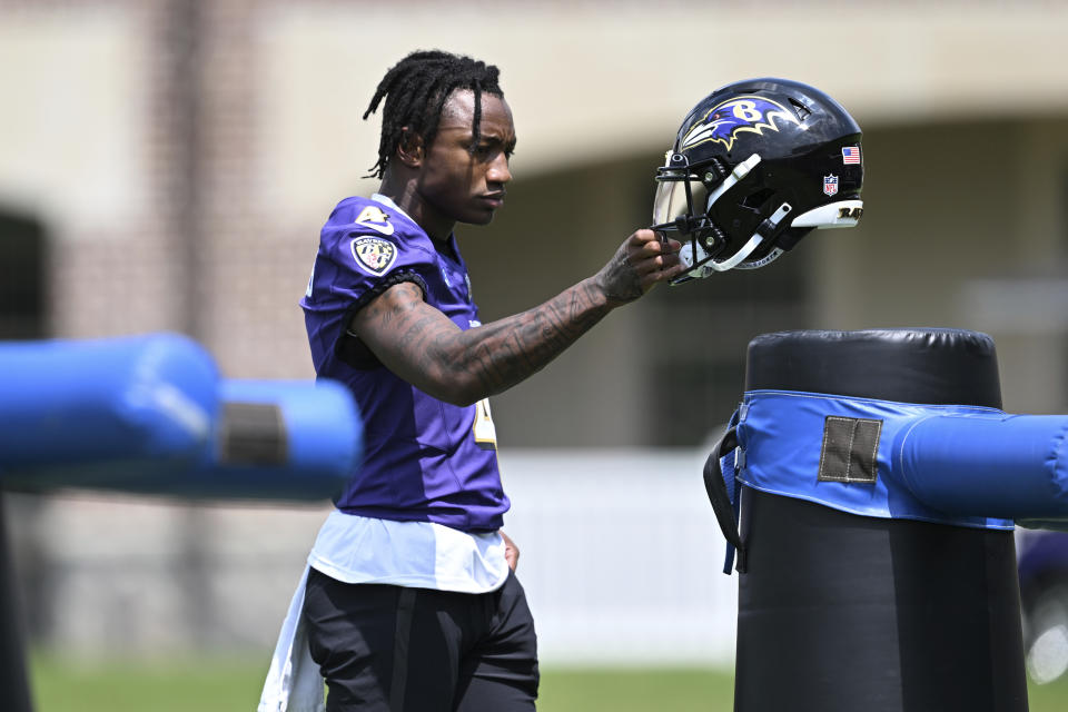 Baltimore Ravens wide receiver Zay Flowers takes a break during NFL football training camp practice, Wednesday, July 26, 2023, in Owings Mills, Md. (AP Photo/Gail Burton)