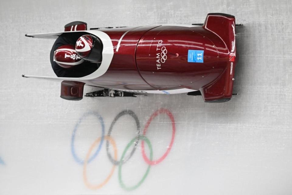 A bobsled at the Olympics on a track that's perpendicular to the floor