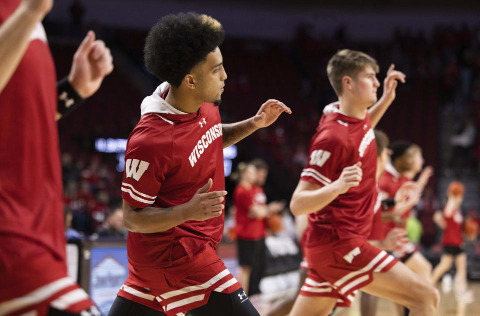 Wisconsin's Chucky Hepburn, center, stretches before playing against Nebraska in an NCAA college basketball game Thursday, Feb. 1, 2024, in Lincoln, Neb. (AP Photo/Rebecca S. Gratz)