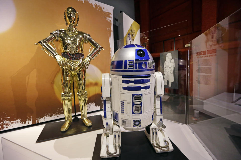 C-3PO, left, and R2-D2 costumes. (AP Photo/Elaine Thompson)