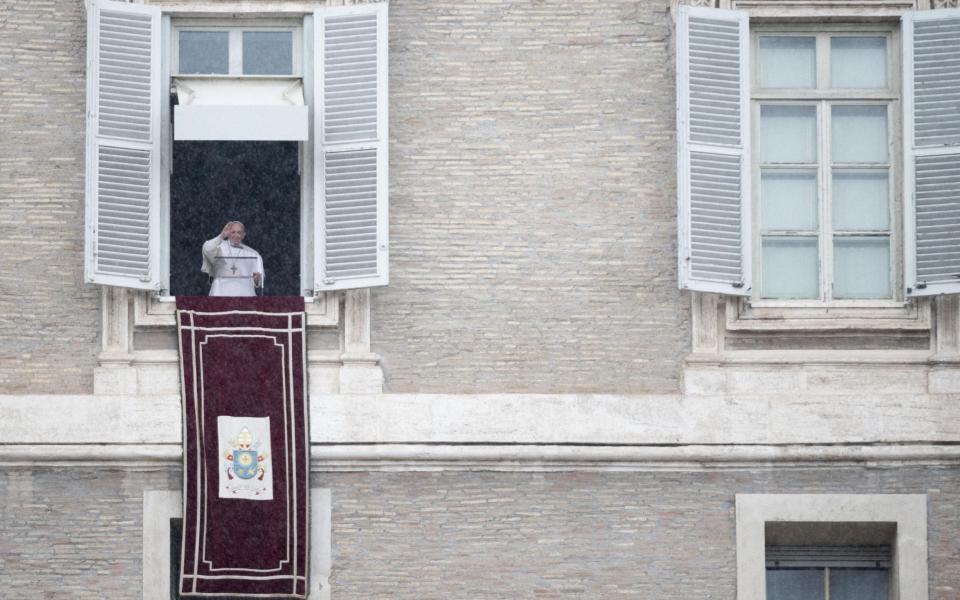 Pope Francis waves as he leads his Sunday Angelus Prayer from his window overlooking Saint Peter's Square at the Vatican - CLAUDIO PERI/EPA-EFE/Shutterstock