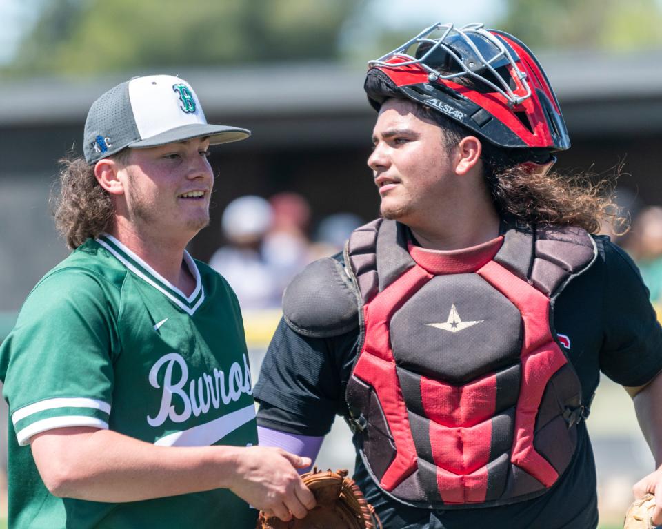 Burroughs' Conner Batzer, left, celebrates with Oak Hills' Leyland Riley after escaping a bases-loaded jam during the all-star baseball game at Hesperia High School on Saturday, June 4, 2022.