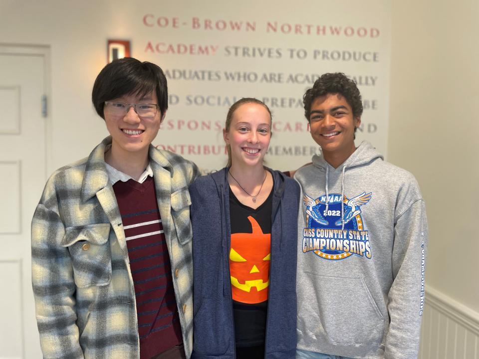 National Merit Scholarship Semifinalists Nikhil Chavda and John Zhang, and Commended Student Megan Adams, celebrate their notification of recognition in the National Merit Scholarship Program. From left to right are J. Zhang, M. Adams, and N. Chavda.