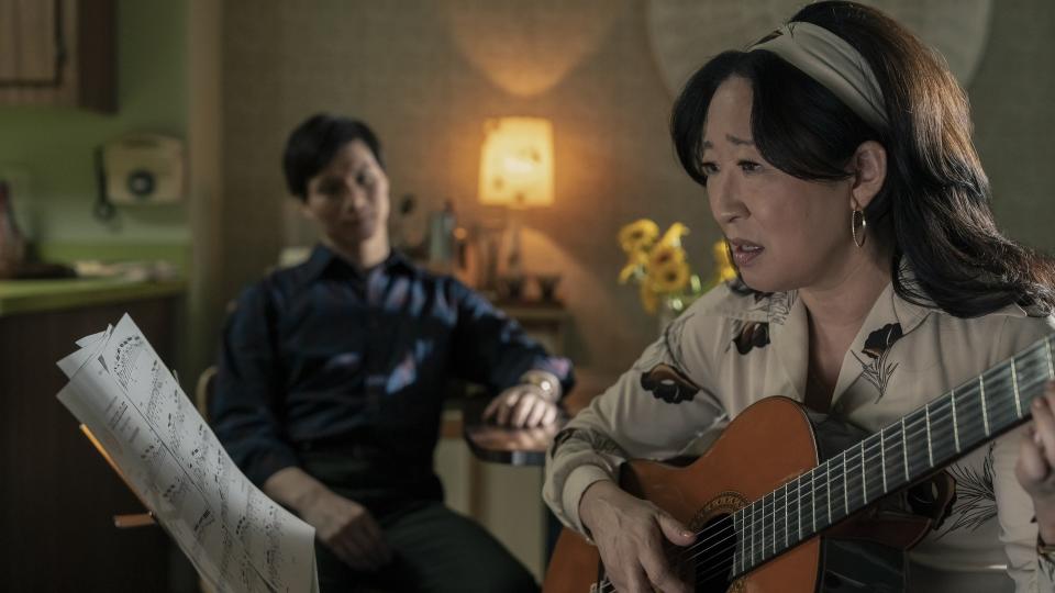 Sandra Oh holding a guitar in The Sympathizer