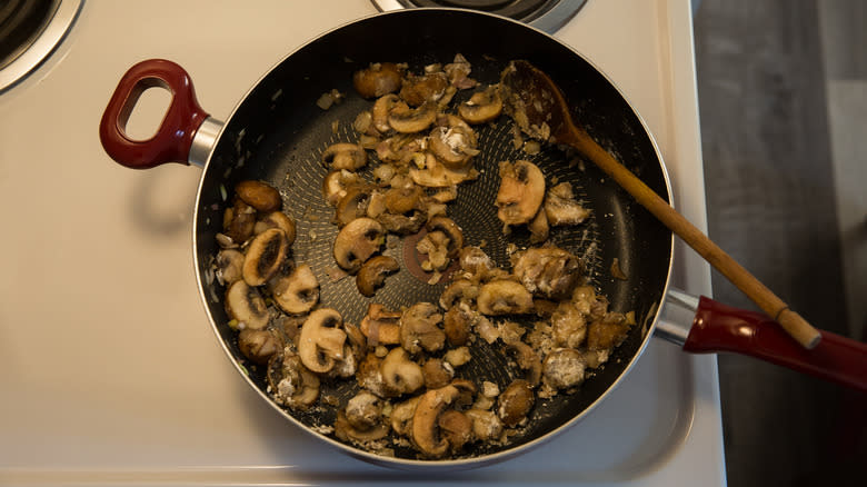 mushrooms sauteing in large pan 