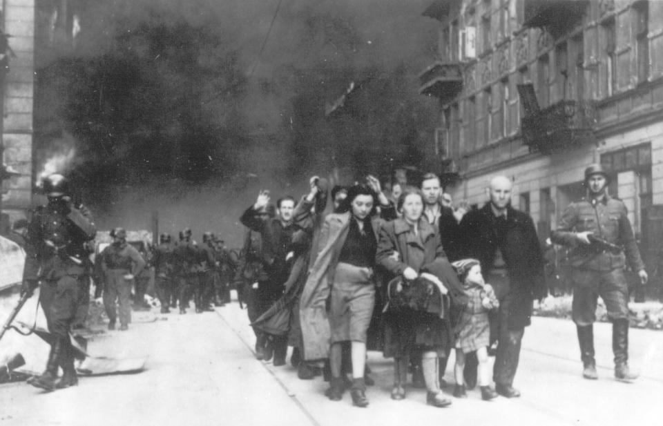 FILE - In this 1943 file photo, a group of Polish Jews are led away for deportation by German SS soldiers during the destruction of the Warsaw Ghetto by German troops after an uprising in the Jewish quarter ghetto by German soldiers on April 19, 1943. Almost 80 years after the Holocaust, about 245,000 Jewish survivors are still living across more than 90 countries, according to the report by the New York-based Conference on Jewish Material Claims Against Germany. (AP Photo, File)