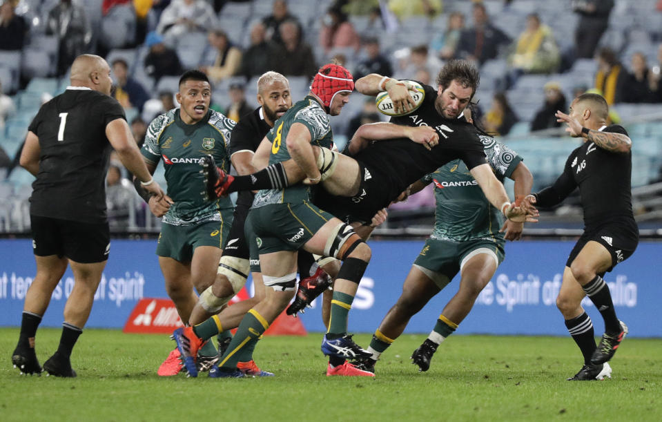 New Zealand's Sam Whitelock is tackled by Australia's Harry Wilson during the Bledisloe rugby test between the All Blacks and the Wallabies at Stadium Australia, Sydney, Australia, Saturday, Oct. 31, 2020. (AP Photo/Rick Rycroft)