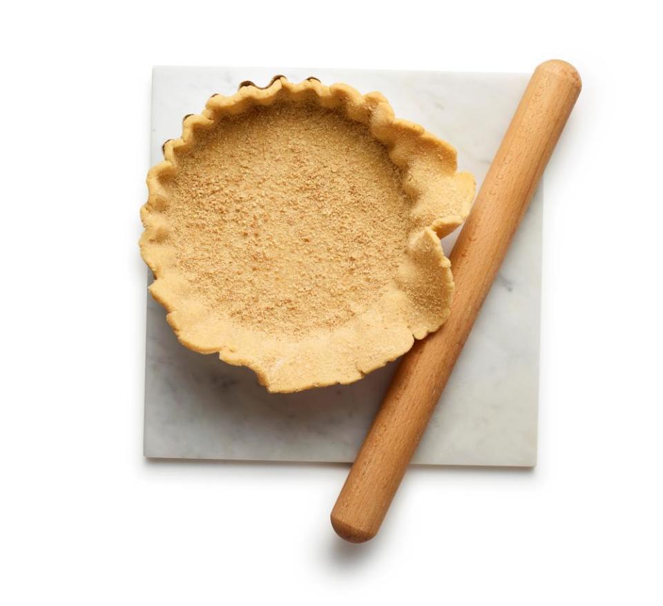 Felicity Cloake's lemon meringue pie step 4. Roll the dough and biscuit base and lay over the tin.