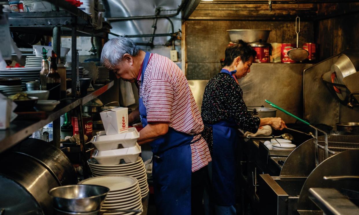 <span>Paul and Nancy Fong, owners of Chicago Cafe, cook in the kitchen on 13 March 2024 in Woodland, California.</span><span>Photograph: Andri Tambunan/The Guardian</span>