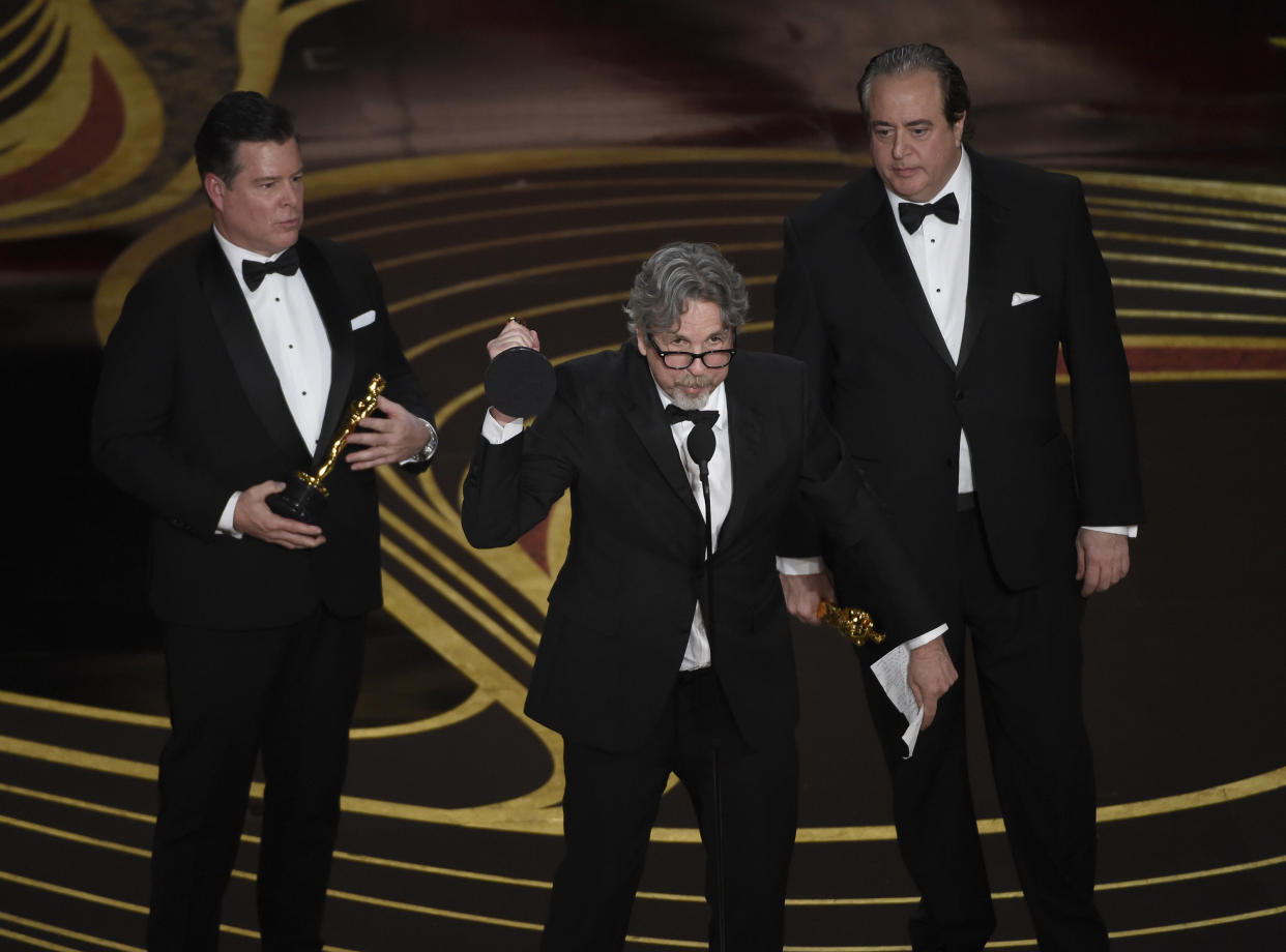 Brian Hayes Currie, from left, Peter Farrelly and Nick Vallelonga accept the award for best original screenplay for “Green Book” at the Oscars on Sunday, Feb. 24, 2019, at the Dolby Theatre in Los Angeles. (Photo by Chris Pizzello/Invision/AP)