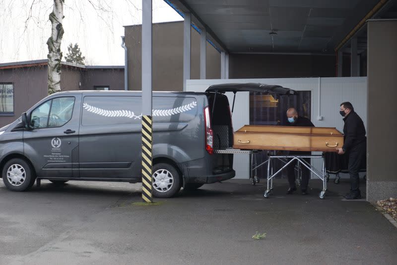 Funeral workers brings a coffin of a person who passed away due to coronavirus disease (COVID-19) at crematory in Ostrava