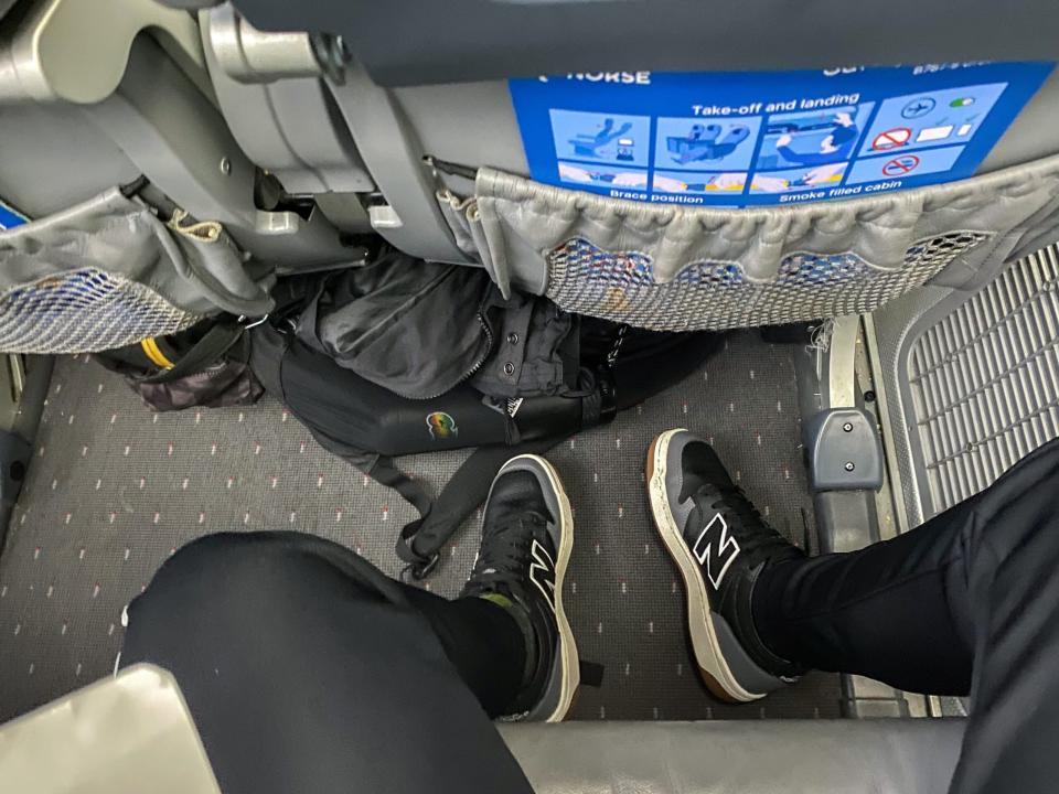 The author's legs while seated on a plane.