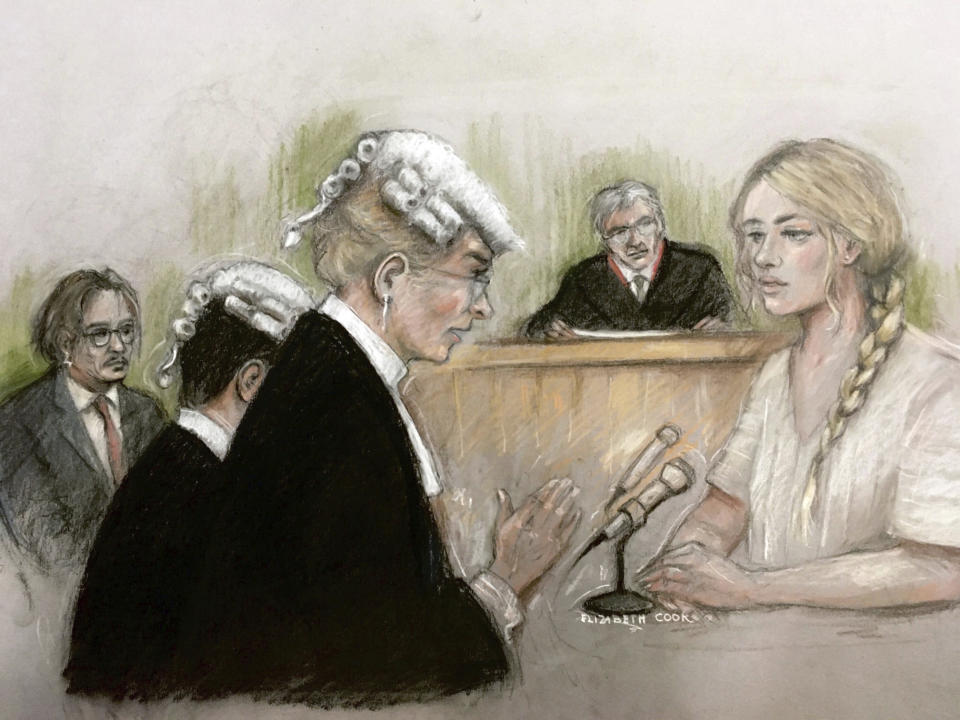 In this court artist sketch by Elizabeth Cook, actress Amber Heard being questioned by Sasha Wass QC as she gives evidence at the High Court in London, Monday July 20, 2020. Amber Heard has begun giving testimony at Britain’s High Court against ex-husband Johnny Depp, who she has accused of abusing her both physically and verbally during their tempestuous relationship. Depp, 57, is suing News Group Newspapers, publisher of the Sun, and the paper’s executive editor, Dan Wootton, at the court in London over an April 2018 article that called him a “wife-beater.” The Hollywood star strongly denies abusing Heard. (Elizabeth Cook via PA via AP)