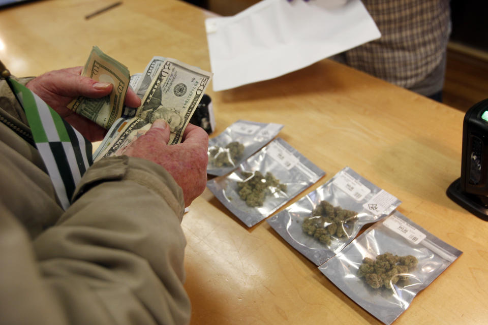 <p>A customer purchases marijuana at Harborside marijuana dispensary, Monday, Jan. 1, 2018, in Oakland, Calif. (Photo: Mathew Sumner/AP) </p>