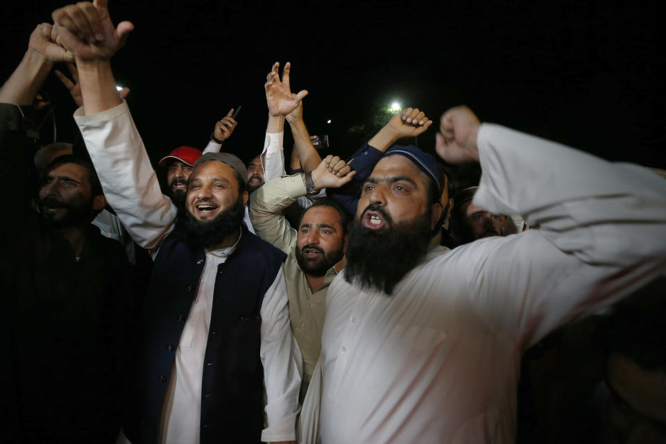 Supporters of an opposition party chant slogans as they celebrate the success of a no-confidence vote against Prime Minister Imran Khan outside the National Assembly, in Islamabad, Pakistan, Sunday, April 10, 2022. Pakistan's political opposition ousted the country's embattled prime minister in a no confidence vote on Saturday, which they won after several of Imran Khan's allies and a key coalition party deserted him. (AP Photo/Anjum Naveed)