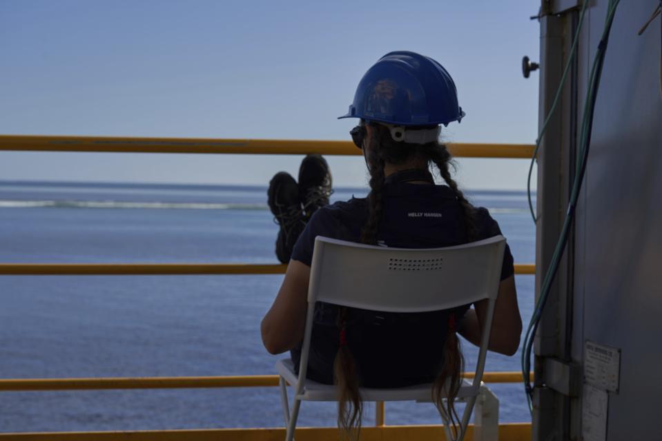 Marine scientist Louise Allcock looks out over the sea as she awaits the outcome of a mission to recover a lost ROV (Remotely Operated Vehicle) off the coast of the tiny island of Alphonse, Seychelles, Wednesday March 13, 2019. The accident has impacted the scientific mission as the camera-carrying ROV is a vital image-gathering tool that can go deeper than the submersibles. The previous day, an accident severed the cable connecting the drone to the mother-ship of the British-based Nekton mission. (AP Photo/David Keyton)