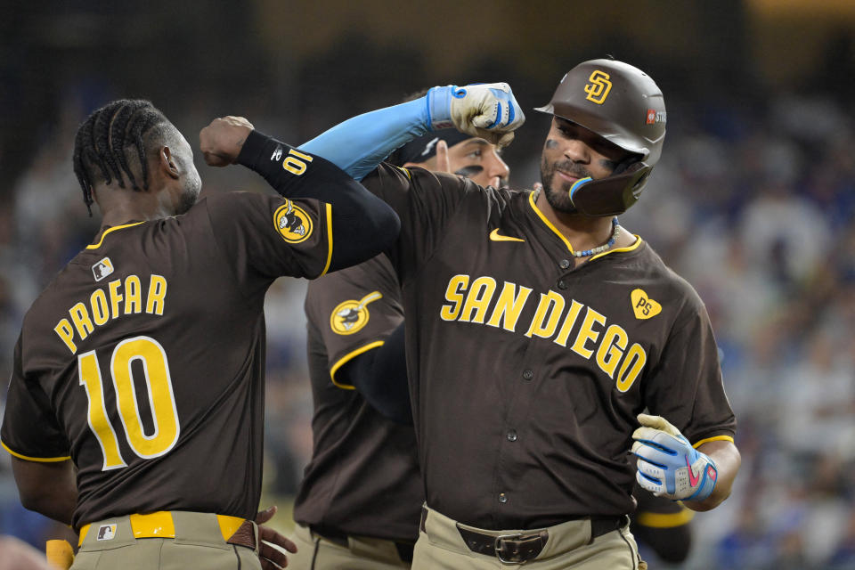 Oct 6, 2024; Los Angeles, California, USA; San Diego Padres second baseman Xander Bogaerts (2) celebrates with outfielder Jurickson Profar (10) after hitting a solo home run in the eighth inning against the Los Angeles Dodgers during game two of the NLDS for the 2024 MLB Playoffs at Dodger Stadium. Mandatory Credit: Jayne Kamin-Oncea-Imagn Images