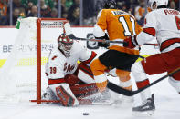 Philadelphia Flyers' Travis Konecny (11) cannot get the puck past Carolina Hurricanes' Alex Nedeljkovic (39) as Haydn Fleury (4) defends during the second period of an NHL hockey game, Thursday, March 5, 2020, in Philadelphia. (AP Photo/Matt Slocum)