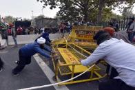 NEW DELHI, INDIA - JANUARY 26: Demonstrators removing police barricades during the farmers tractor rally at Daryaganj on Republic Day, on January 26, 2021 in New Delhi, India. Major scenes of chaos and mayhem at Delhi borders as groups of farmers allegedly broke barricades and police check posts and entered the national capital before permitted timings. Police used tear gas at Delhi's Mukarba Chowk to bring the groups under control. Clashes were also reported at ITO, Akshardham. Several rounds of talks between the government and protesting farmers have failed to resolve the impasse over the three farm laws. The kisan bodies, which have been protesting in the national capital for almost two months, demanding the repeal of three contentious farm laws have remained firm on their decision to hold a tractor rally on the occasion of Republic Day.(Photo by Sanjeev Verma/Hindustan Times via Getty Images)