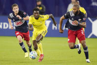 Nashville SC forward Abu Danladi (7) dribbles the ball ahead of New England Revolution's Scott Caldwell, left, and Andrew Farrell, right, during the first half of an MLS soccer match Friday, Oct. 23, 2020, in Nashville, Tenn. (AP Photo/Mark Humphrey)