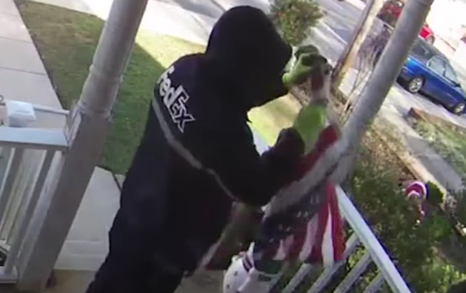A Marine veteran was caught on camera folding a woman’s American flag that had fallen to the ground. (Photo: YouTube/WBAL-TV 11)