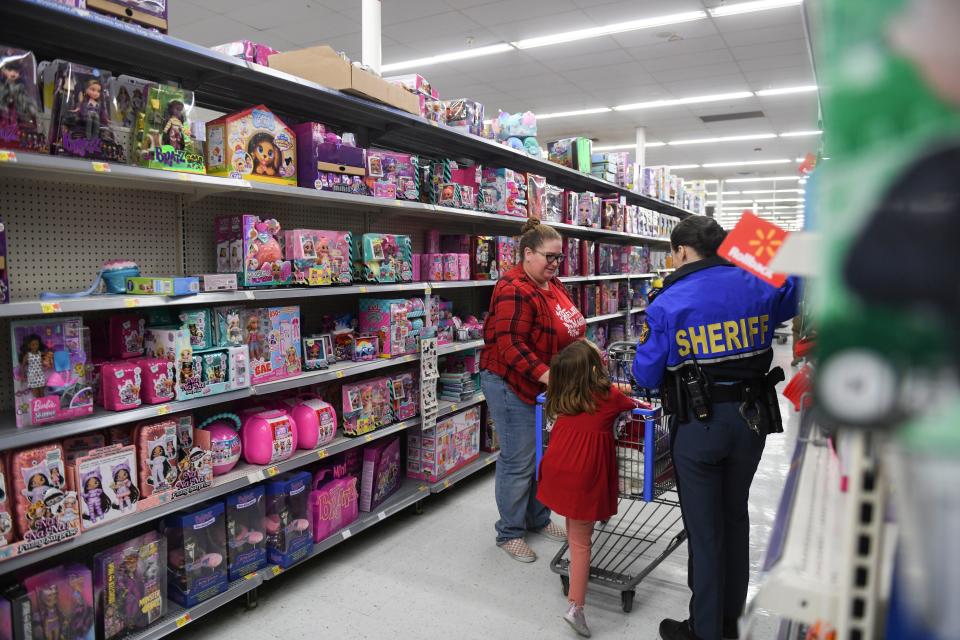 Kids shop with deputies during the Columbia County Sheriff's Office Day with a Deputy at Walmart on Thursday, Dec. 21, 2023.