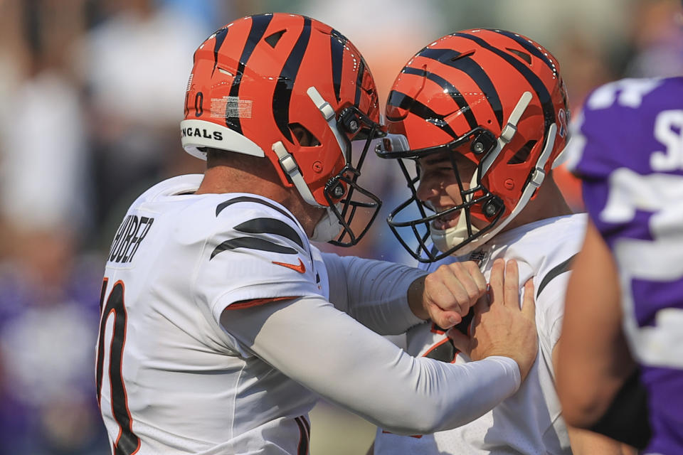 Cincinnati Bengals kicker Evan McPherson, right, celebrates with holder Kevin Huber, left, after making a field goal to defeat the Minnesota Vikings during overtime of an NFL football game, Sunday, Sept. 12, 2021, in Cincinnati. (AP Photo/Aaron Doster)