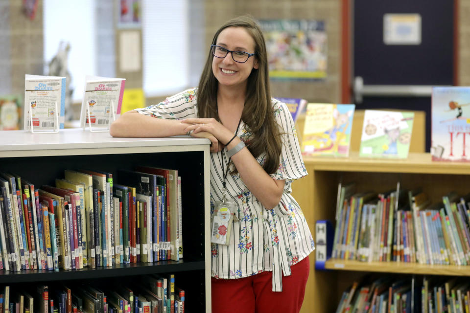 First-grade teacher Hillary Madrigal is photographed at her school Thursday, Aug. 22, 2019, in Salt Lake City. Across the country, teachers and school districts alike are grappling with the latest political and economic realities of educator pay. Madrigal jumped to the nearby school district last year, lured by higher salaries that would allow her to quit her second job as a housekeeper and buy a new car. (AP Photo/Rick Bowmer)