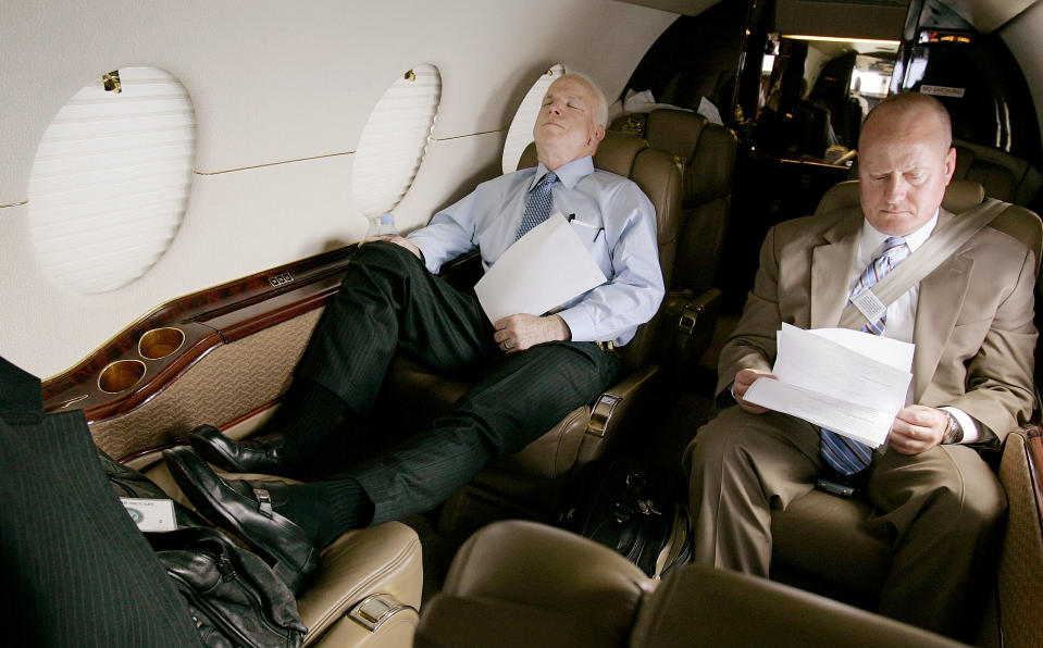 <p>Senator John McCain catches a nap on a private jet as he leaves Dulles International Airport in Virginia Monday afternoon, April 23, 2007, en route to a series of fund raisers in Connecticut, while his legislative assistant, Joe Donoghue, looks over some paperwork. (Photo: Stephan Savoia/AP) </p>