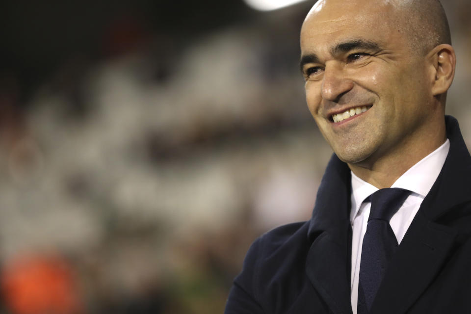 FILE - In this photo taken on Thursday, Oct. 10, 2019, Belgium's coach Roberto Martinez smiles prior to the Euro 2020 group I qualifying soccer match between Belgium and San Marino at the King Baudouin Stadium in Brussels. Martinez has signed a new contract to lead the Red Devils through the 2022 World Cup in Qatar. (AP Photo/Francisco Seco)