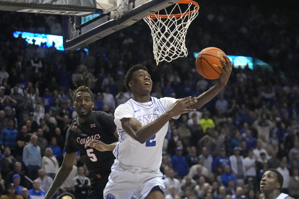 BYU guard Jaxson Robinson (2) goes to the basket as Houston forward Ja'Vier Francis (5) defends during the second half of an NCAA college basketball game Tuesday, Jan. 23, 2024, in Provo, Utah. (AP Photo/Rick Bowmer)