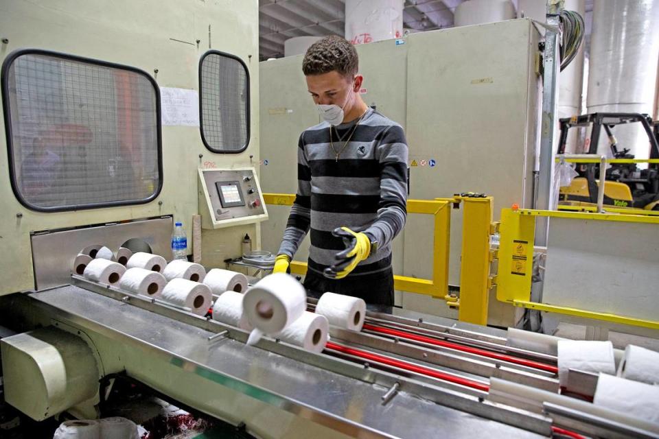 Daisel Figueroa inspects rolls of toilet paper at South Florida Tissue Paper Company in Miami Gardens, Florida, March 26, 2020. The Corzo family’s company has been working around the clock to produce the precious commodity since coronavirus triggered panic buying of toilet paper.