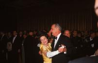 <p>Lyndon Johnson shares the first dance at his inaugural ball with his wife, Lady Bird Johnson. The new First Lady wore a yellow satin ball gown designed by John Moore. The dress was later <a href="https://www.si.edu/newsdesk/photos/lady-bird-johnsons-inaugural-coat-1965" rel="nofollow noopener" target="_blank" data-ylk="slk:gifted to the Smithsonian;elm:context_link;itc:0;sec:content-canvas" class="link ">gifted to the Smithsonian</a> for preservation. </p>