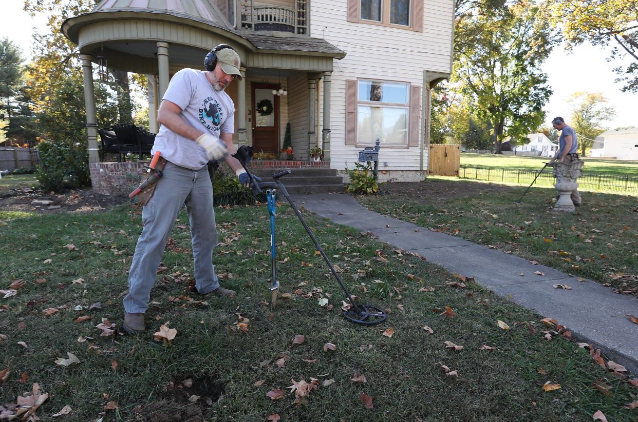 Kentucky Dirt Diggers Jared Handley, left, and Zeb Hargis search for precious metals on Zeb's brother's property in Henderson, Ky. on Oct. 23, 2023. Their business has generated a growing social media following.