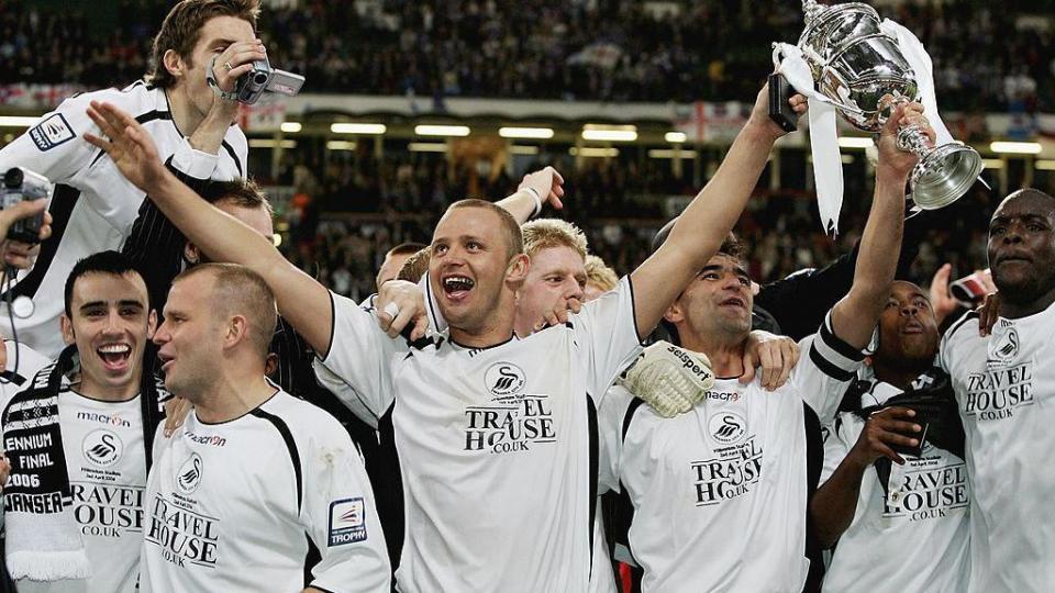 Lee Trundle celebrates the trophy with his Swansea team mates