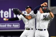 Oct 18, 2017; Bronx, NY, USA; New York Yankees center fielder Aaron Hicks (31) and right fielder Aaron Judge (99) celebrates after beating the Houston Astros in game five of the 2017 ALCS playoff baseball series at Yankee Stadium. Mandatory Credit: Robert Deutsch-USA TODAY Sports